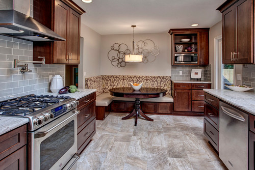 River White Countertop with Gloss Finish Ceramic Subway Tiles, Porcelain Flooring Tiles, Cherry Cabinets and Ironwork Wall Decor , Breakfast Nook and Kitchen Pendant Lights